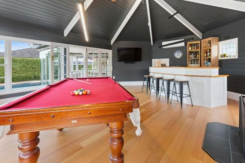 a pool table in the middle of a room at Kirinaran Manor Pool & Bar Room in Frankston South