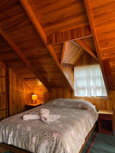 a bedroom with a bed in an attic at Rincón Uruguayo in Monteverde Costa Rica