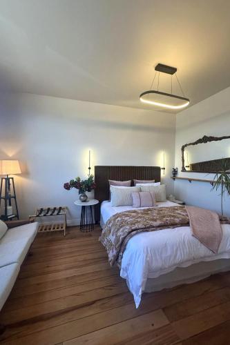 a bedroom with a large bed and a mirror at The Verdict in Martinborough