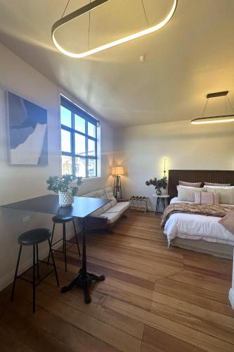 a bedroom with a bed and a desk and a table at The Verdict in Martinborough