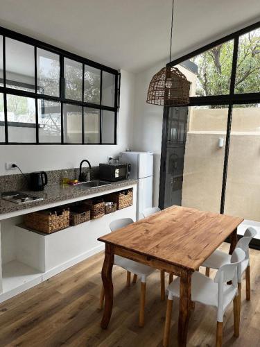 a kitchen with a wooden table and chairs in a room at La Vicenta in Jesús María