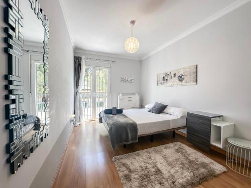 a bedroom with a bed and a large window at Sunset Marbella in Marbella