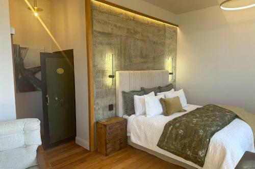 a bedroom with a bed with a large headboard at The Advocate in Martinborough