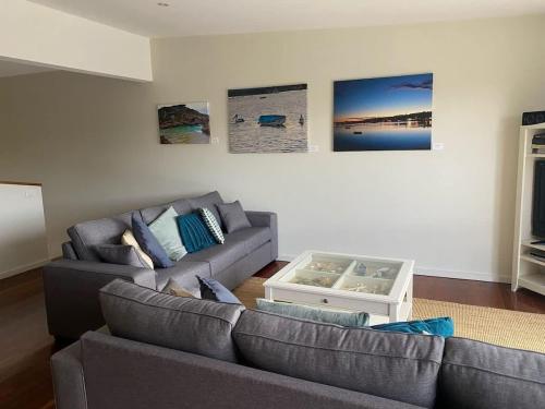 a living room with a couch and a table at Coastal Escape in Tura Beach
