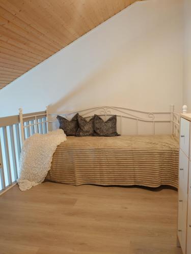 a bedroom with a bed with pillows on it at Holidayhome RintintinTahko in Tahkovuori
