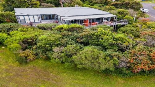 an aerial view of a house on a hill with bushes at Bantry Two in Merimbula