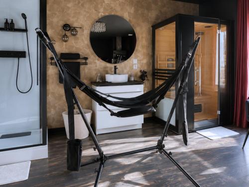 a hammock in a bathroom with a mirror at ღ Love Room intime - Sauna - Hmm OH Oui ღ in Saint-Quentin