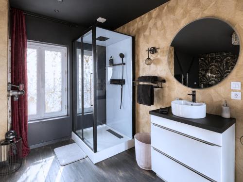 a bathroom with a sink and a mirror at ღ Love Room intime - Sauna - Hmm OH Oui ღ in Saint-Quentin