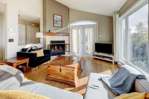 a living room with a couch and a fireplace at 2CH - Fireplace Panoramic View - Upper Unit in Petite-Rivière-Saint-François