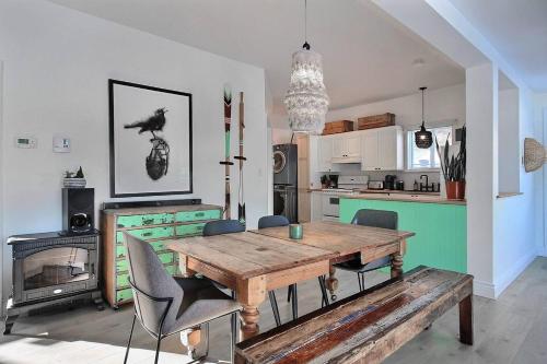 a kitchen with a wooden table and chairs in a room at Lakefront Chalet Hot Tub & Fire Pit Sleeps 6 in Saint-Raymond