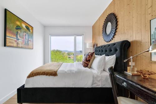 a bedroom with a bed and a desk with a mirror at 3CHParkingGymRooftop97 Walkscore10mins QC in Quebec City