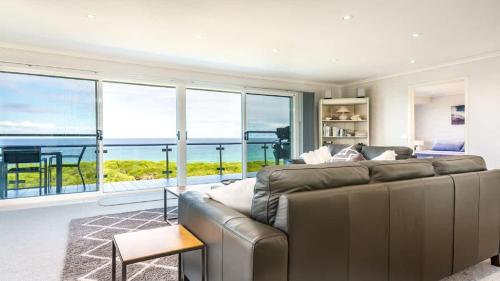 a living room with a couch and a view of the ocean at Quarterdeck 6 in Tura Beach