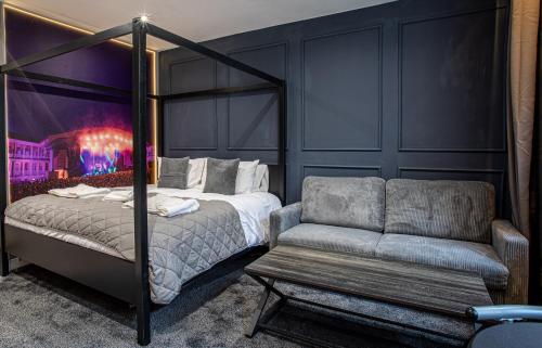 a bedroom with a bed and a couch at The Piece Hall Harmony Designer Studio - Superking in Halifax