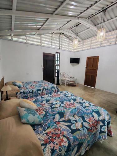 a large bedroom with two beds and a couch at El Carao in Talamanca