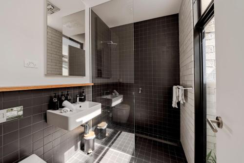 a bathroom with a sink and a toilet at Stella on Stevens in Queenscliff
