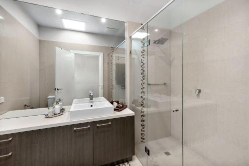 a bathroom with a sink and a shower at The Scoop in Queenscliff