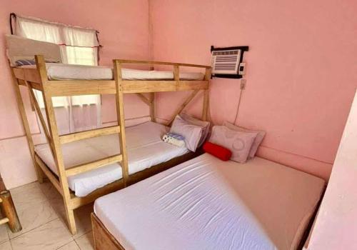 a room with two bunk beds and a bed at Mannor Beach Resort by Hiverooms in Carmen