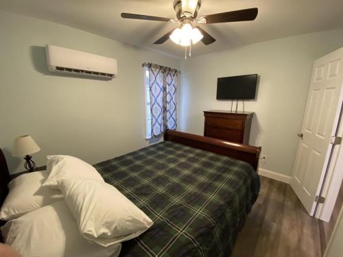 a bedroom with a bed and a ceiling fan at 1 Bed 1 Bath Suite On Strip in Geneva