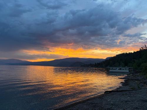 a sunset over a body of water with a boat at Blind Bay Chalet 2 Bedroom Private Suite in Blind Bay