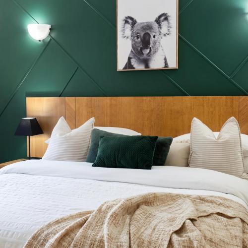 a bedroom with a bed with a picture of a koala at Luxury 2 Bedroom apartment, Treetop views, Resort with 4 swimming pools in Cairns North
