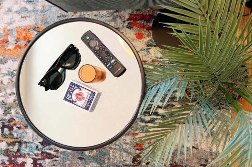 a table with a plate with a remote control and a wallet at King Bed Sleeps 3 2 Beds Walkable Cozy in Philadelphia
