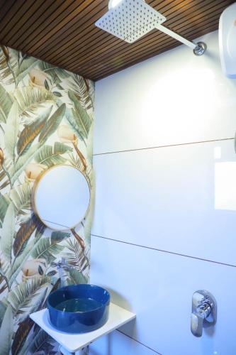 a bathroom with a mirror and a sink at Ashray Guest House in Kalyan