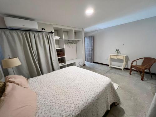 a bedroom with a bed and a table and a chair at Departamento PIPE in Bella Vista
