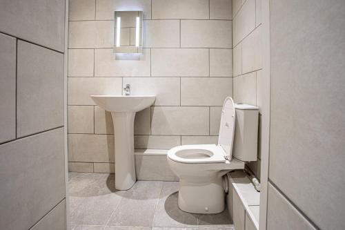 a bathroom with a toilet and a sink at The Piece Hall Harmony Designer Studio - Superking in Halifax