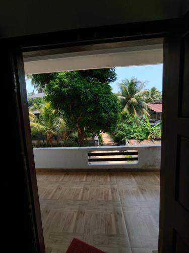 an open door to a room with a hard wood floor at Ram's Heaven in Guruvāyūr