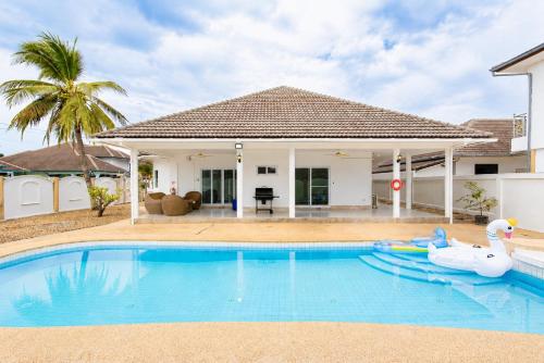 a swimming pool in front of a house at D2 Private Pool Villa Snooker Family & Friends in Hua Hin