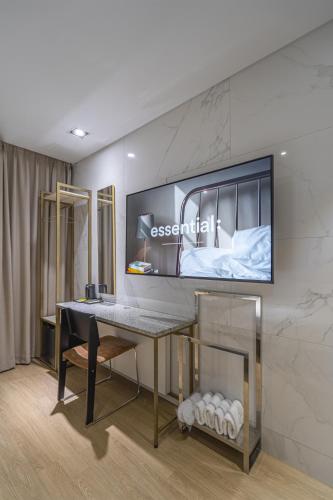 a room with a desk and a television on the wall at Bergen Hotel Daejeon Yuseong in Daejeon