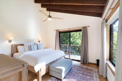 a bedroom with a large bed and a window at Kookaburra Retreat in Berkeley Vale