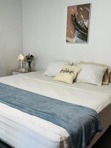 a white bed with two pillows on top of it at Corazón garden in Piura