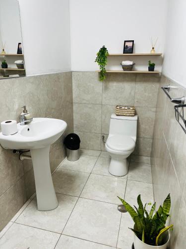 a bathroom with a sink and a toilet at Corazón garden in Piura