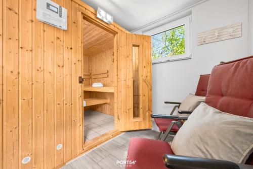 a room with a wooden door with a desk and a chair at Ferienwohnung Luv Dagebüll in Dagebüll