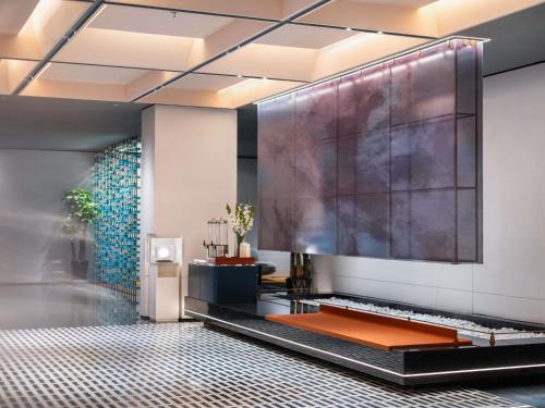 a lobby with a large screen on the wall at Novotel Yangquan High-Tech Zone in Yangquan
