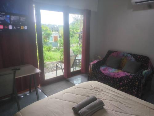 a bedroom with a bed and a view of a window at The Rendezvous Phangan in Ko Phangan