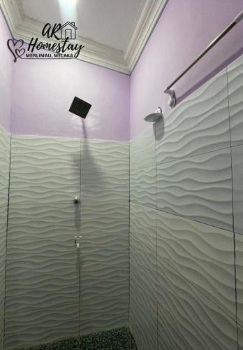 a shower stall in a bathroom with water on the wall at Ar Homestay Merlimau in Merlimau