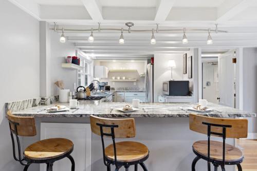 a kitchen with a large island with two bar stools at Crosswinds Near Beach & Shops in Kennebunk