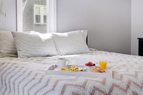 a tray of food and drinks on a bed at Crosswinds Near Beach & Shops in Kennebunk