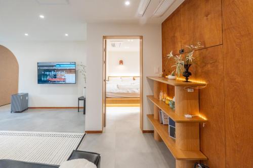 a living room with a mirror and a bedroom at Nakwon Stay 3-Min Walk to Anguk & Jongno 3-ga Stations in Seoul