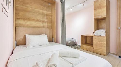 a bedroom with a large white bed and a closet at CoZzzee Hostel in Singapore