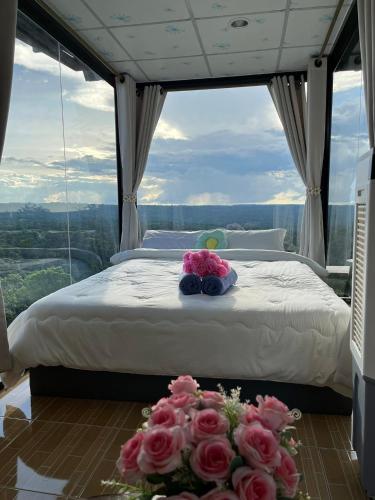 a bedroom with a bed with flowers on the floor at ไร่ปราณปรียา in Campson