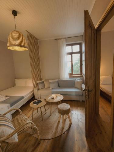 a living room with a couch and a table at Coralia Nest Studio in Glossa