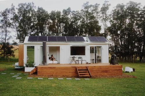 a tiny house with solar panels on the deck at The Antidote Luxe Off-Grid Tiny Home Escape on Private Farm Stay in Farmeadow
