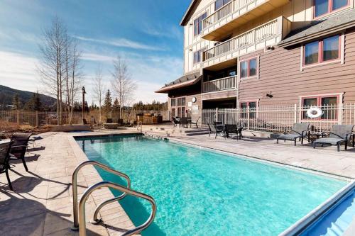 a swimming pool with chairs next to a building at Red Hawk Lodge 2200 in Dillon