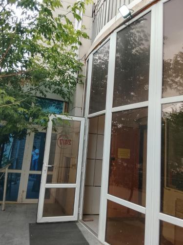 an open door to a building with glass windows at Atom hostel for men in Astana