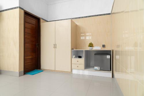 a living room with a tv and a door at Aby Guest House in Sidemen