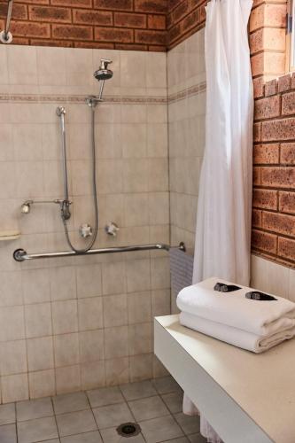 a bathroom with a shower with a shower curtain at Bridge Motor Inn Tocumwal in Tocumwal