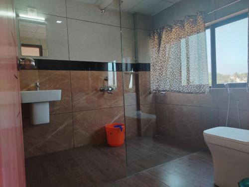 a bathroom with a shower and a toilet and a sink at Ocean Queen Palace Kovalam in Trivandrum